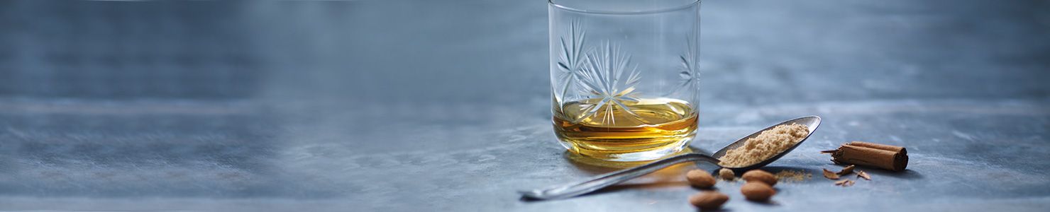 A dram of whisky in a glass tumbler