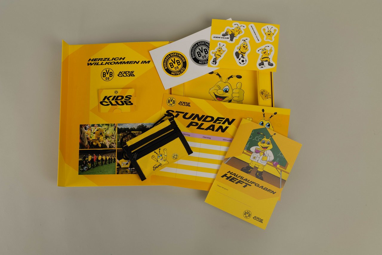 Welcome package for joining the KidsClub (including wallet, writing utensils, membership card, and certificate).