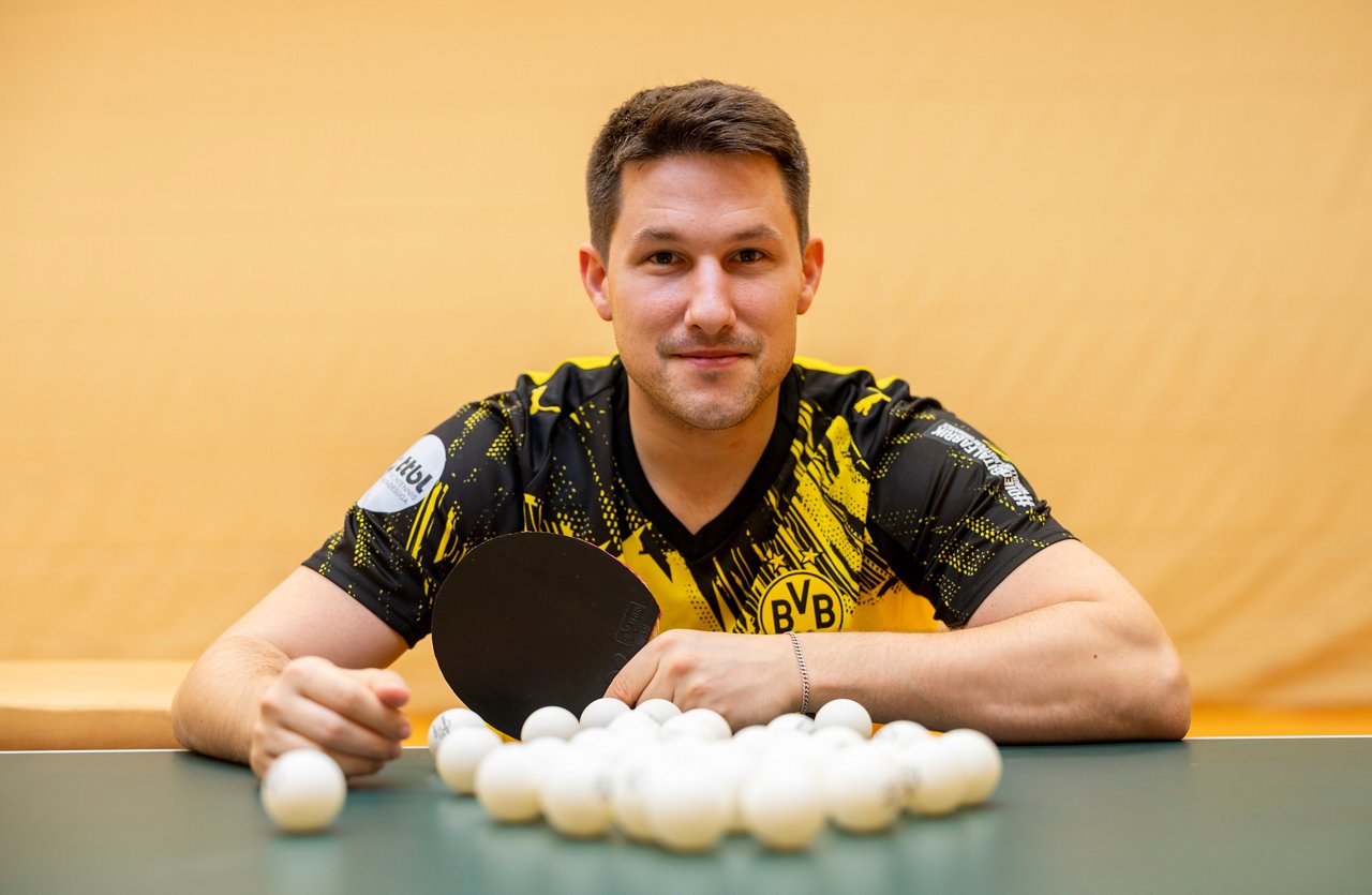 Kristian Karlsson mit Tischtennisbällen und Schläger in der Hand.