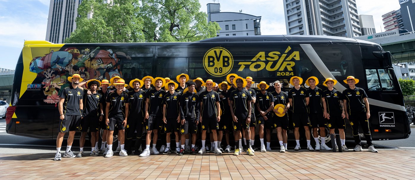 Photo of the BVB team standing in front of the Asia Tour team bus.