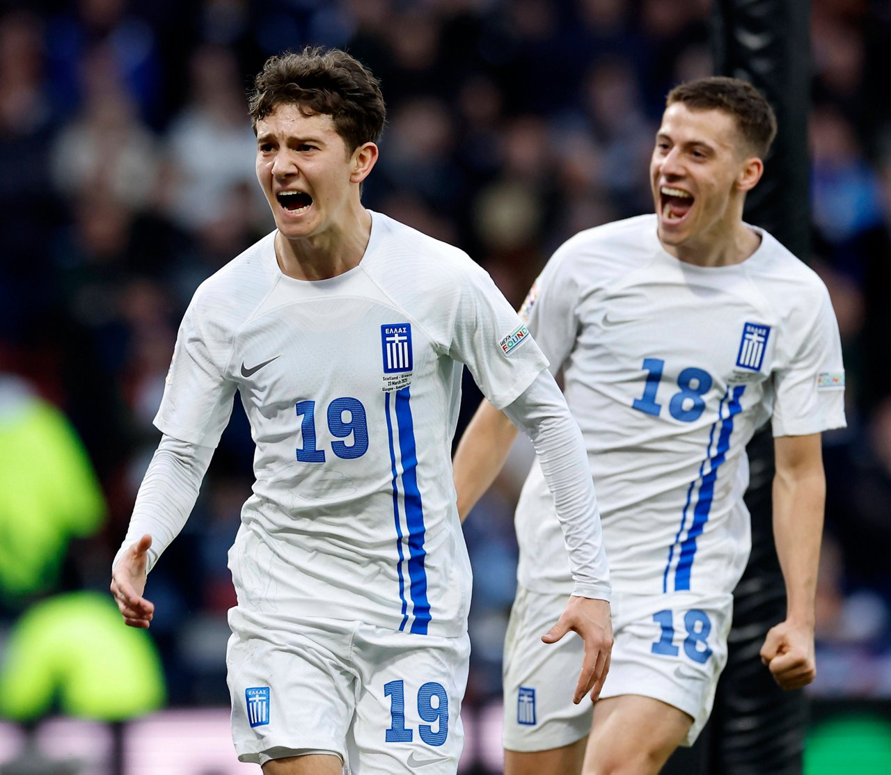 Kosta Karetsas celebrates with Giannis Konstantelias while wearing the Greek national team jersey