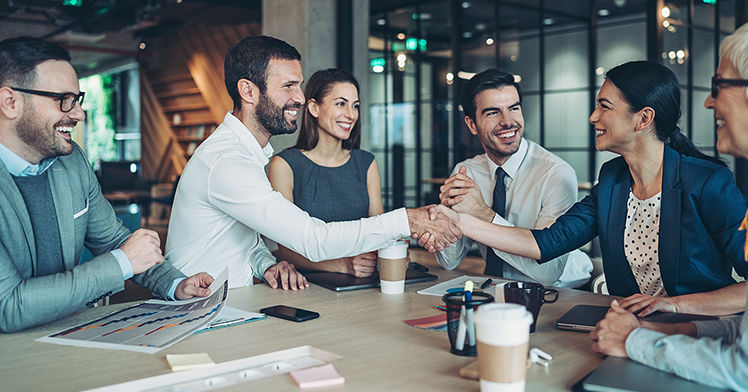 Group of business persons handshake in the office