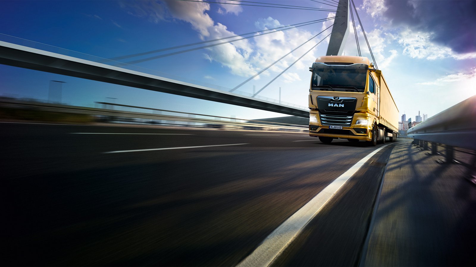 A MAN truck drives over a bridge