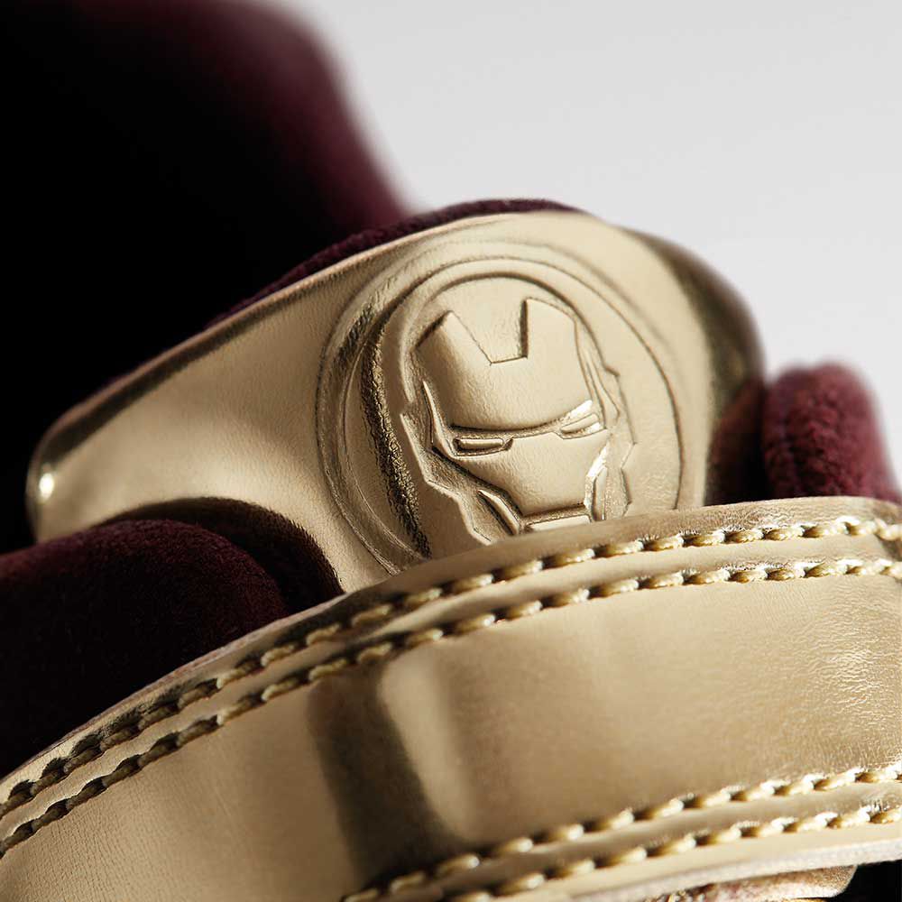 Close up shot of Iron Man's Tri Hero golden badge