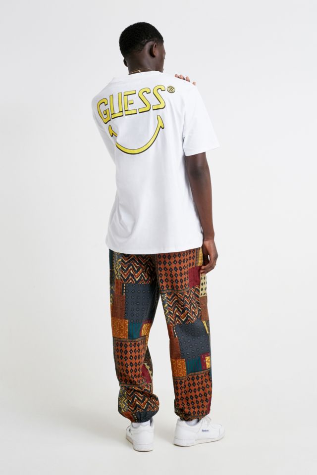 GUESS X Chinatown Market X Smiley Logo T-Shirt | Urban Outfitters UK