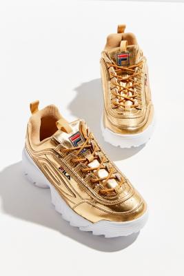 white and gold fila trainers