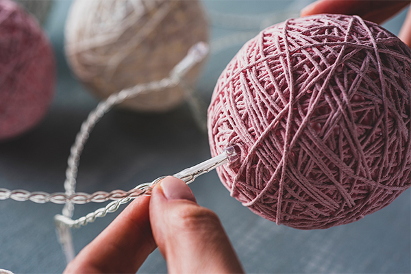 Lichterkette wird in Garnkugel gegeben