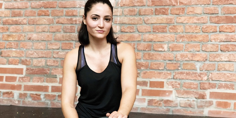 Natacha von the Chocolate Suitcase schaut beim Ausdauer Home Workout in die Kamera