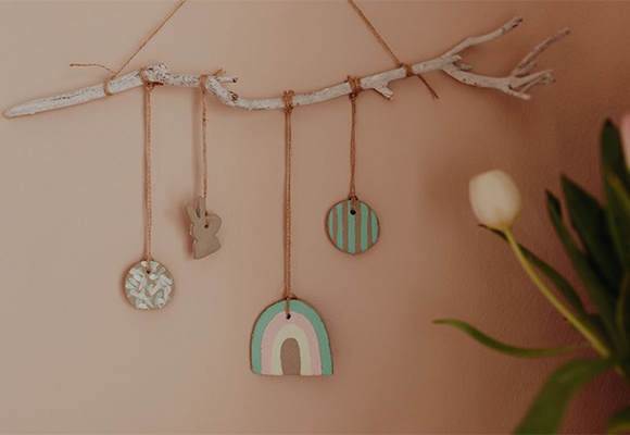 Selbstgemachtes Frühlings-Mobile für das Kinderzimmer aus Kreativbeton an der Wand