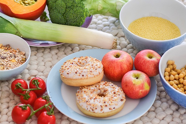 Auswahl an unterschiedlichen Lebensmitteln wie Bananen, Müsli, Porree, Äpfel und Tomaten 