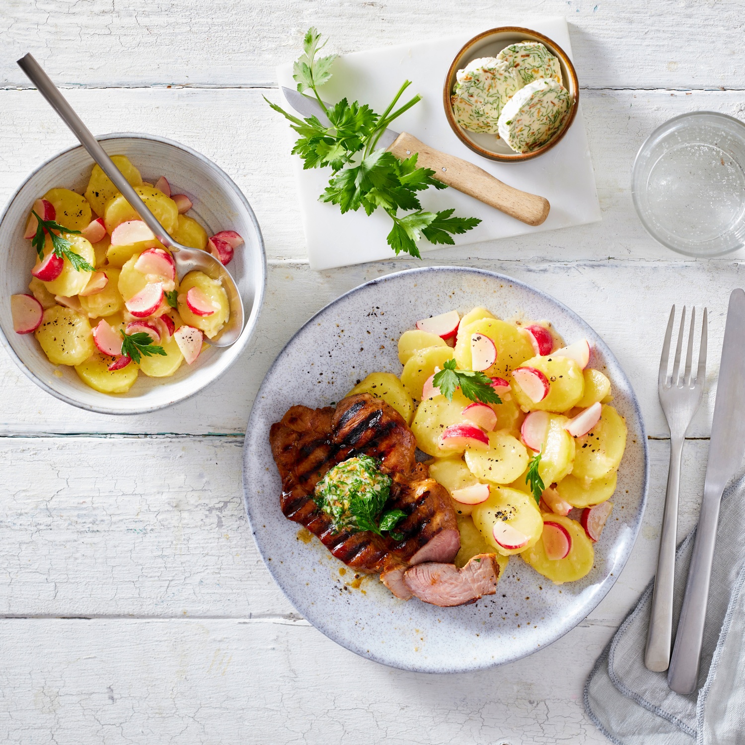 Schweinenackensteak mit pfeffriger Zwiebelbutter und Kartoffel-Radieschen-Salat