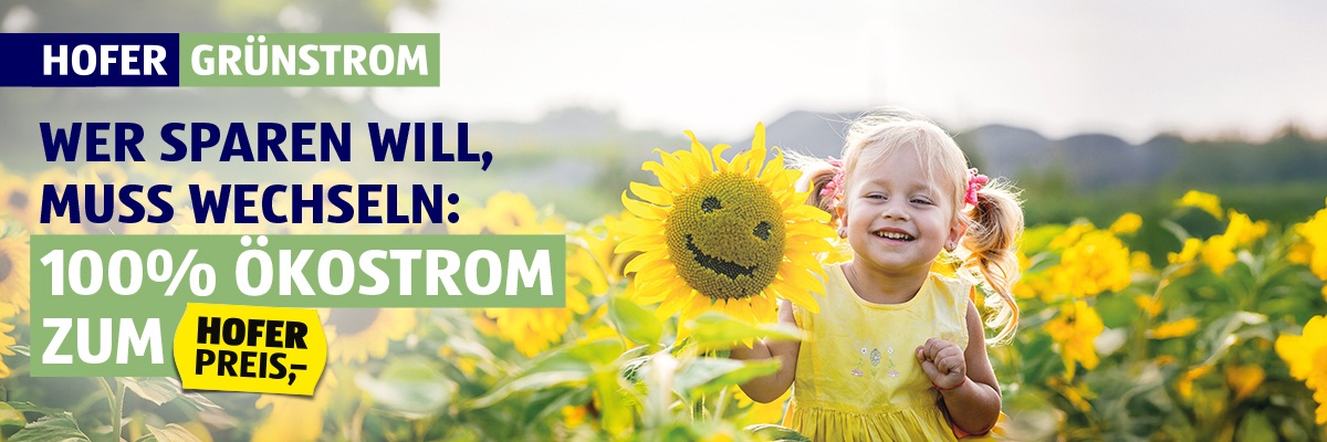 HOFER Grünstrom  - Kind schaut zwischen Sonnenblumen hindurch