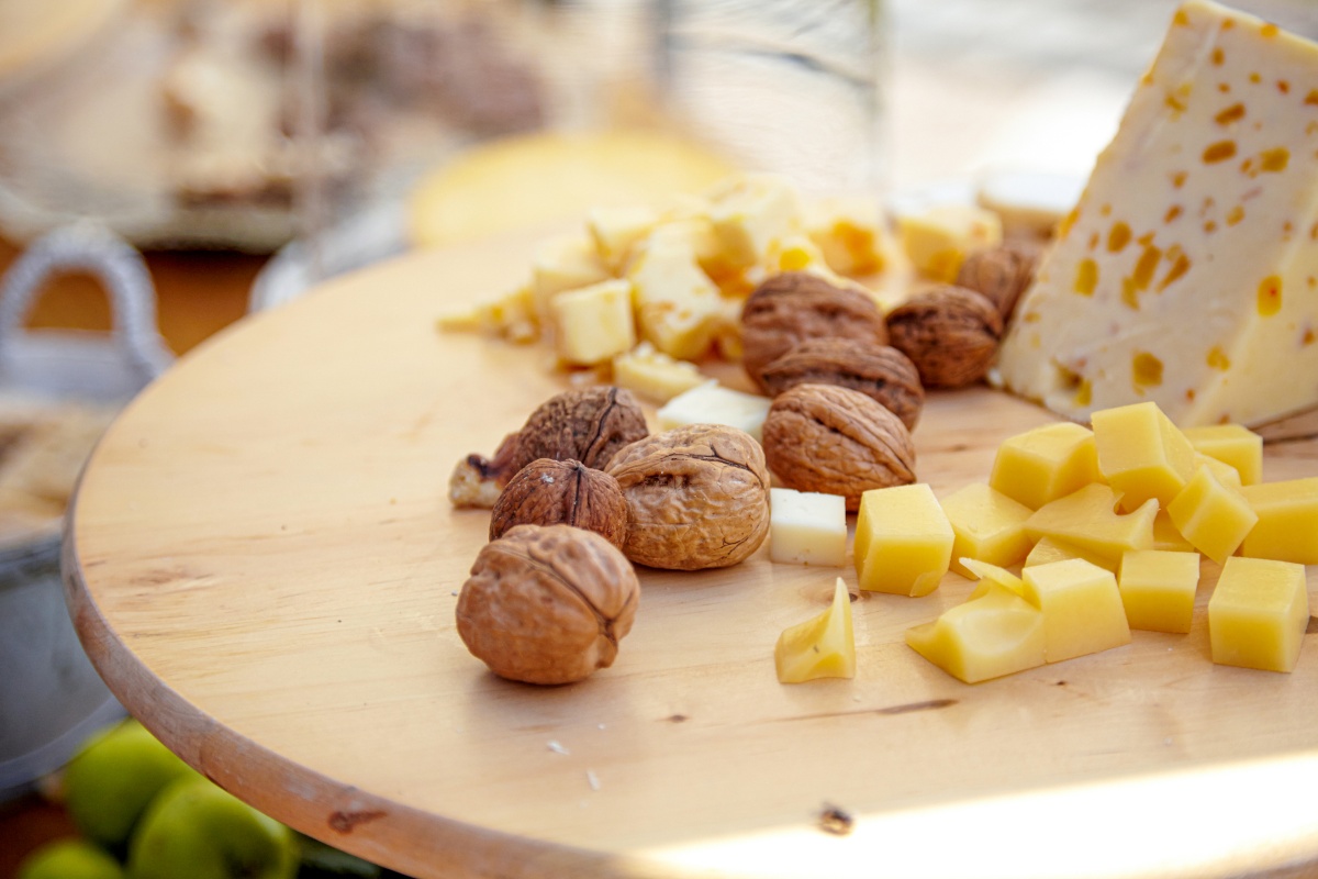 Auf einem Brett liegne Walnüsse und Käse.