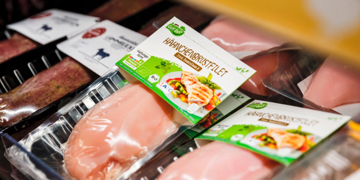 Eine Packung GUT BIO Hänchenbrustfilet liegt im Kühlregal.