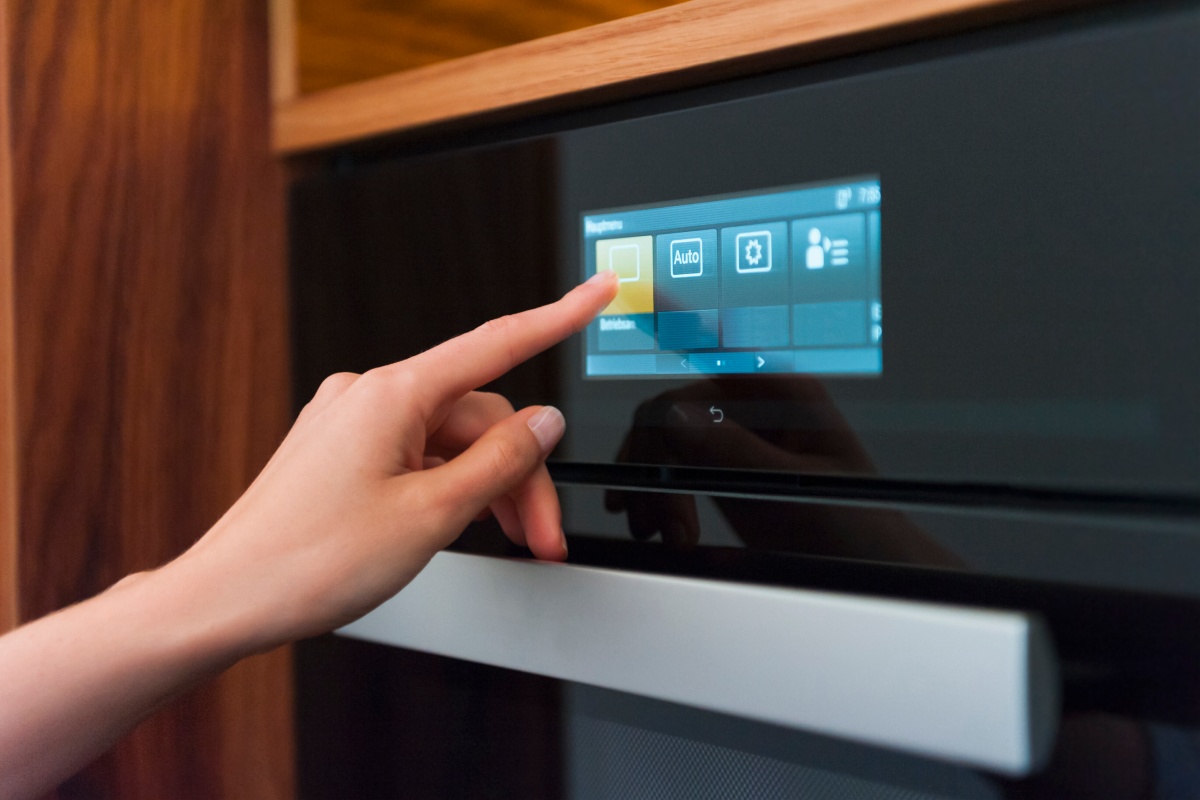 Eine Person stellt das Pyrolyse-Programm eines Backofens an.