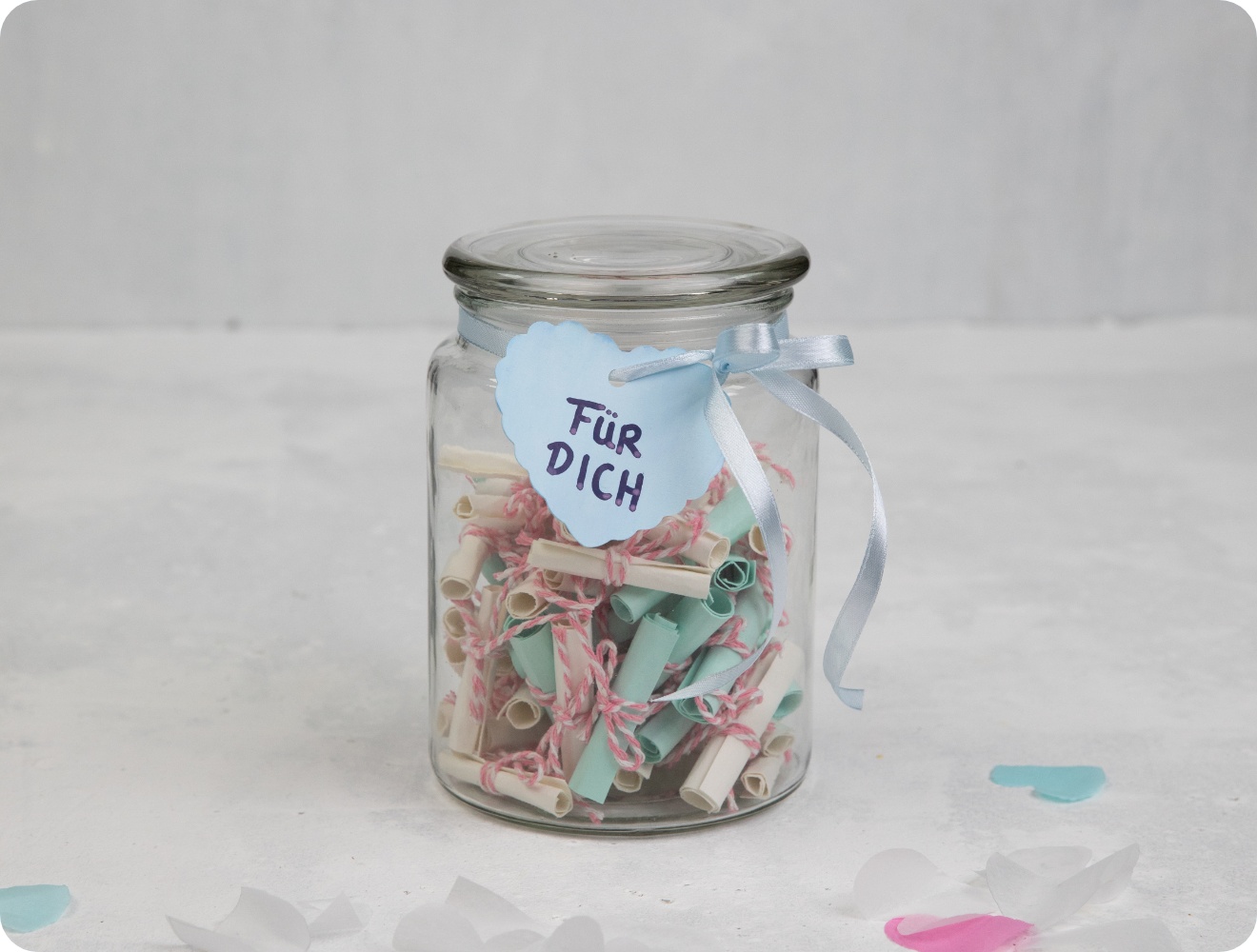 Ein Einmachglas gefüllt mit selbstgestalteten Tombola-Losen zum Muttertag. 