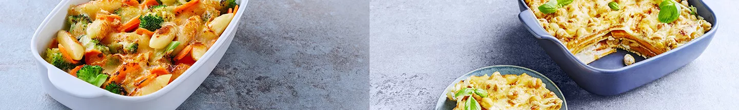 Zwei verschiedene Gerichte in Auflaufformen, die gratiniert worden sind.