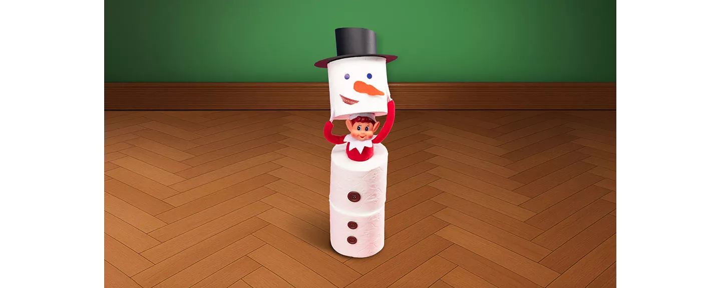 elfo escondido en muñeco de nieve de papel higiénico  