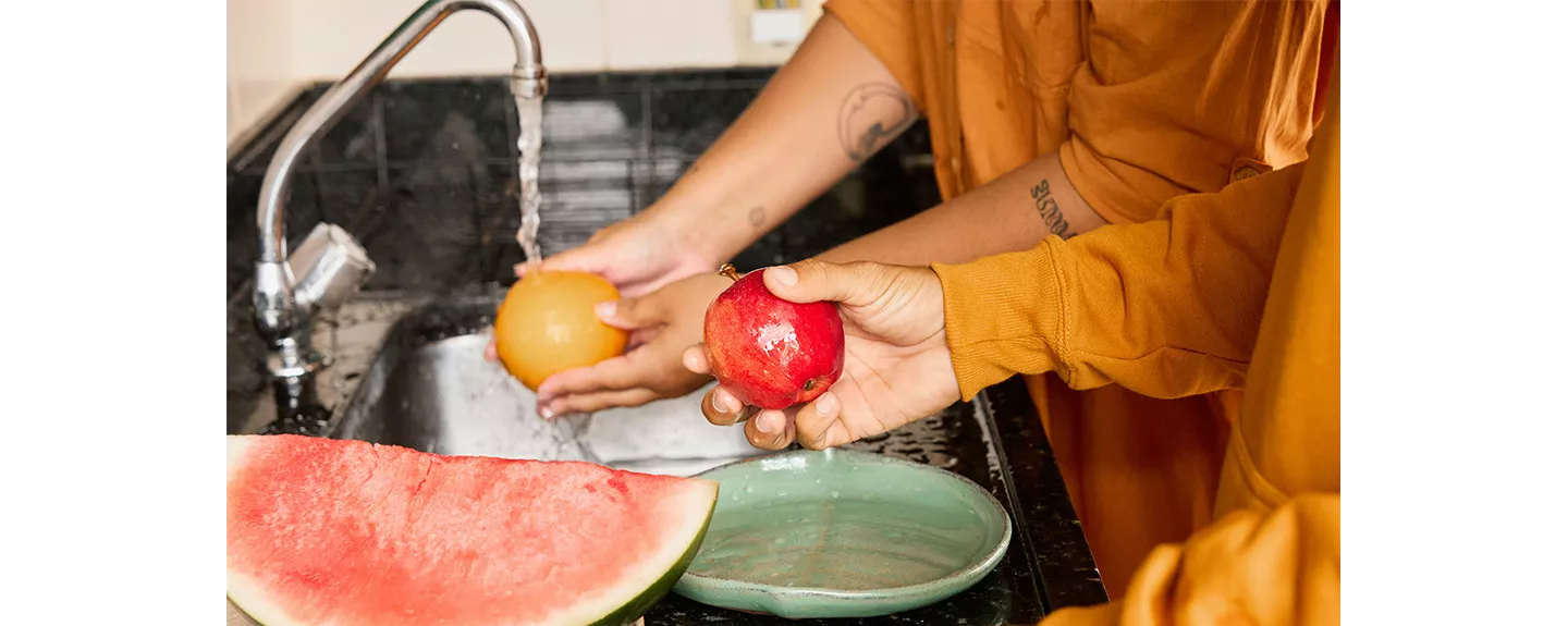 Personas limpiando fruta para prevenir las moscas de la fruta