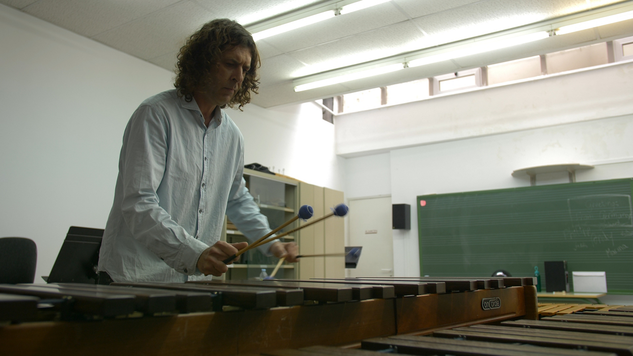 Musician playing marimba in classroom
