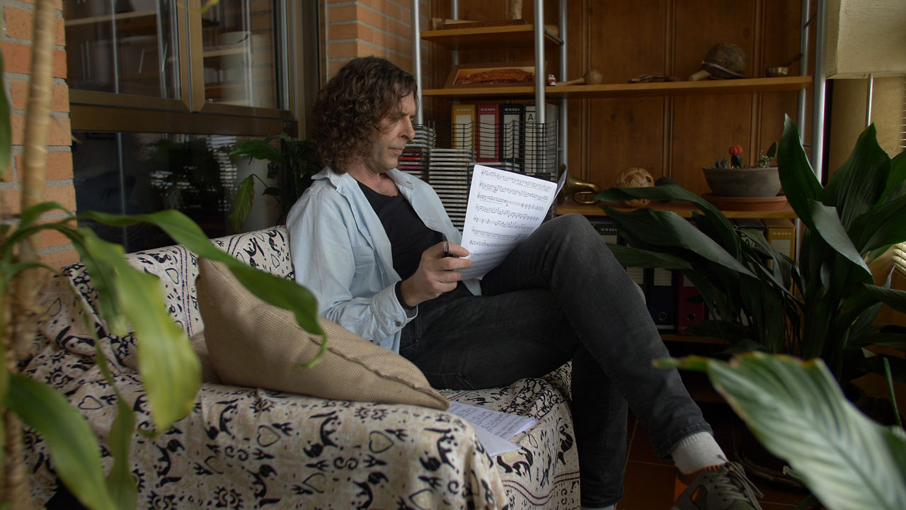 Man reviewing sheet music in cozy living room