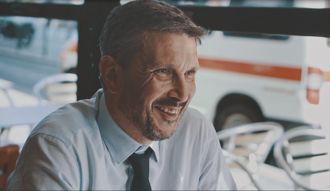 Smiling businessman sitting at street café