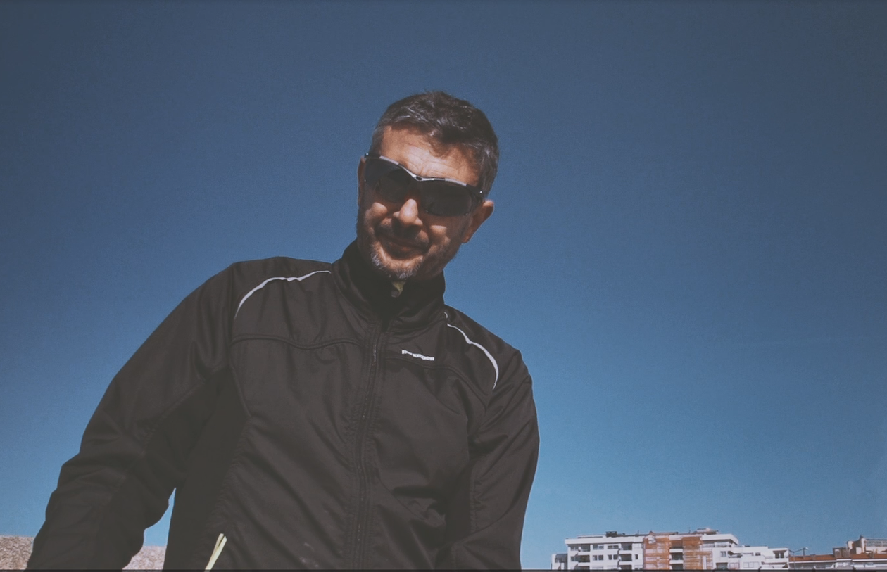 Man in sunglasses outdoors under blue sky