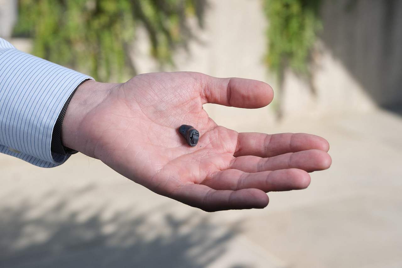 Businessman holding small black object outdoors