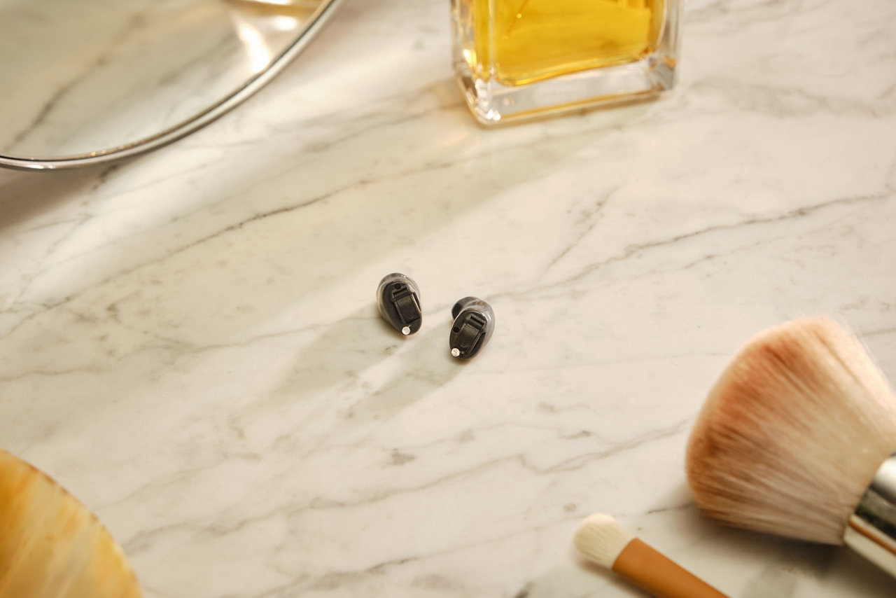 Wireless earbuds on marble vanity surface