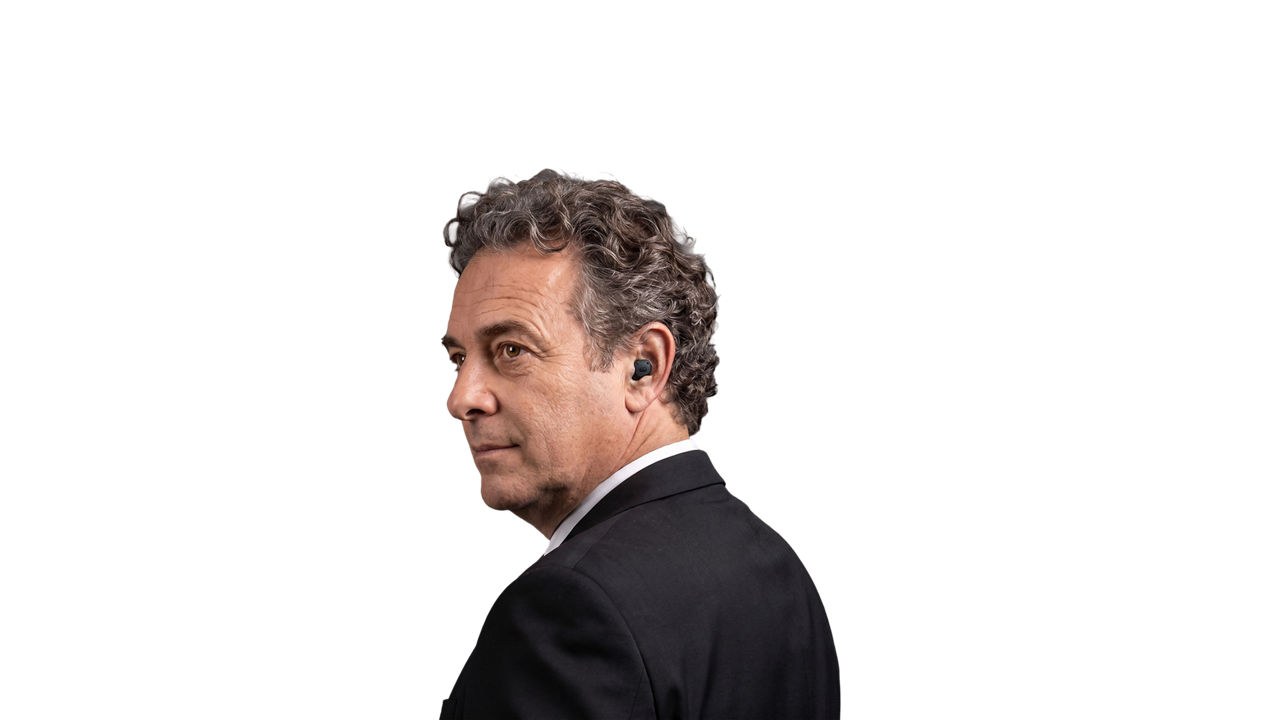 Businessman wearing wireless earbud on black