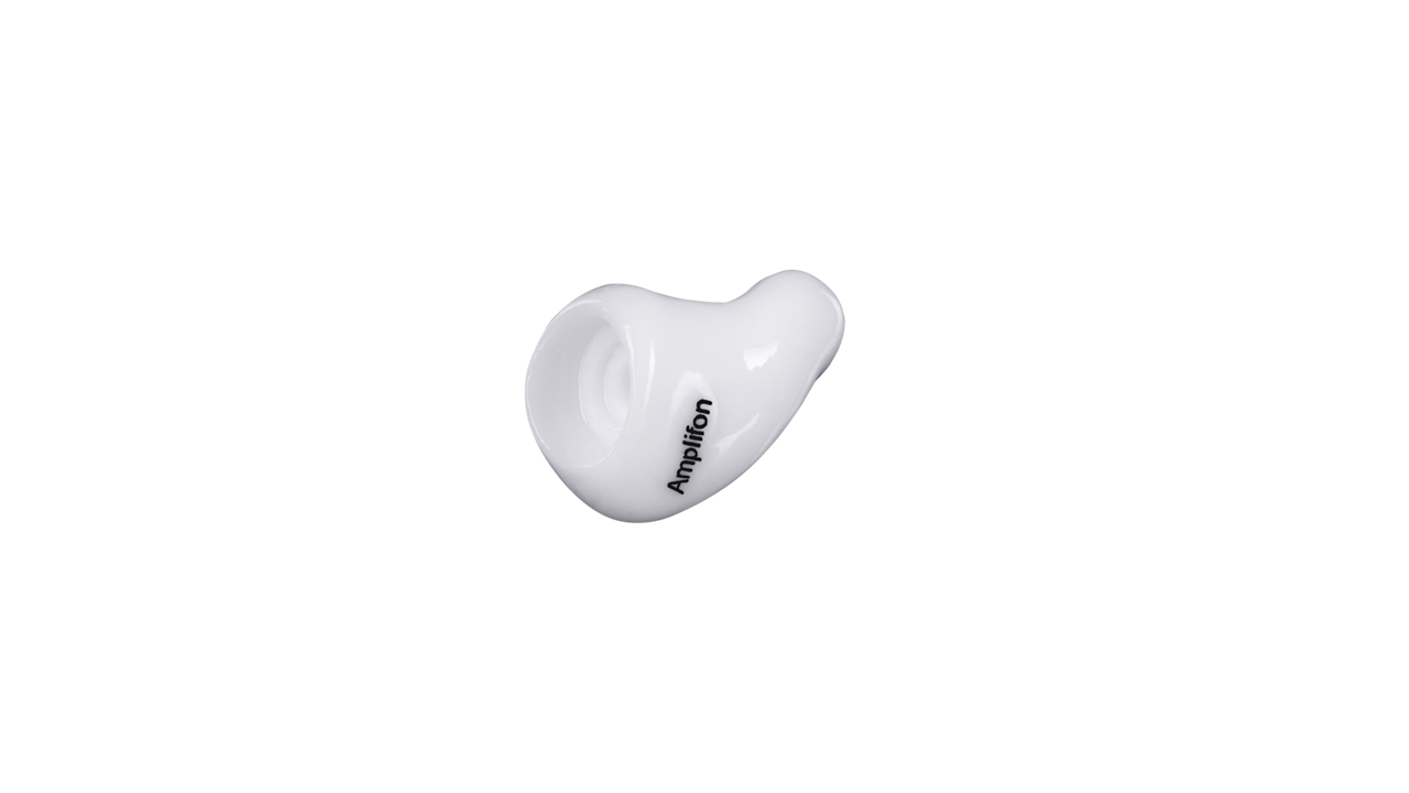 White in-ear hearing device on black background