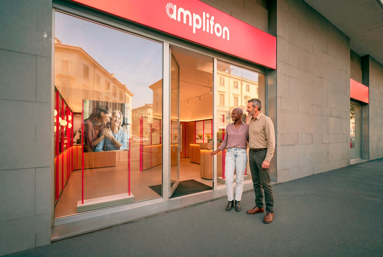 Couple outside Amplifon hearing care storefront