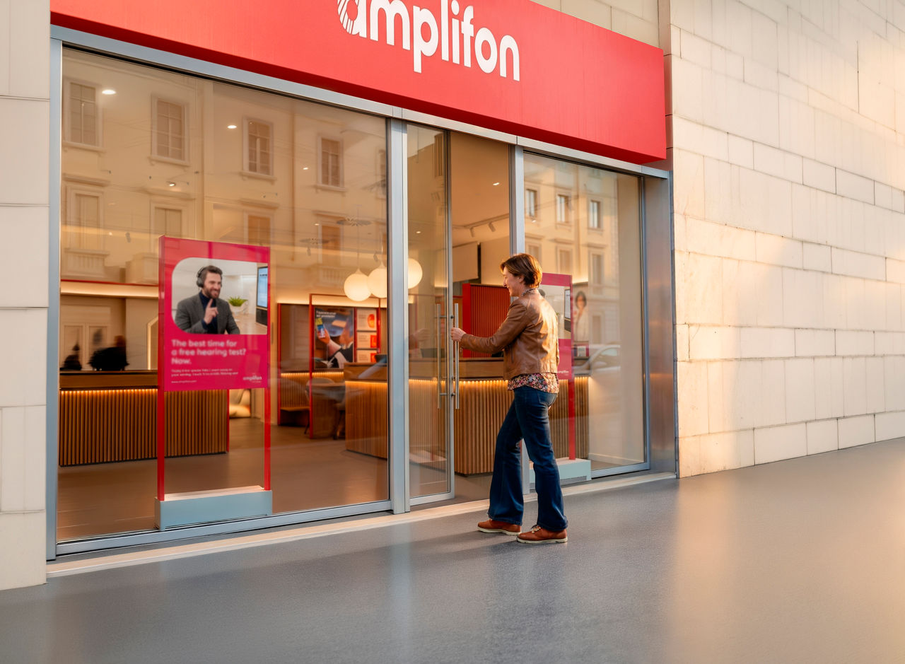 Man entering Amplifon hearing care store