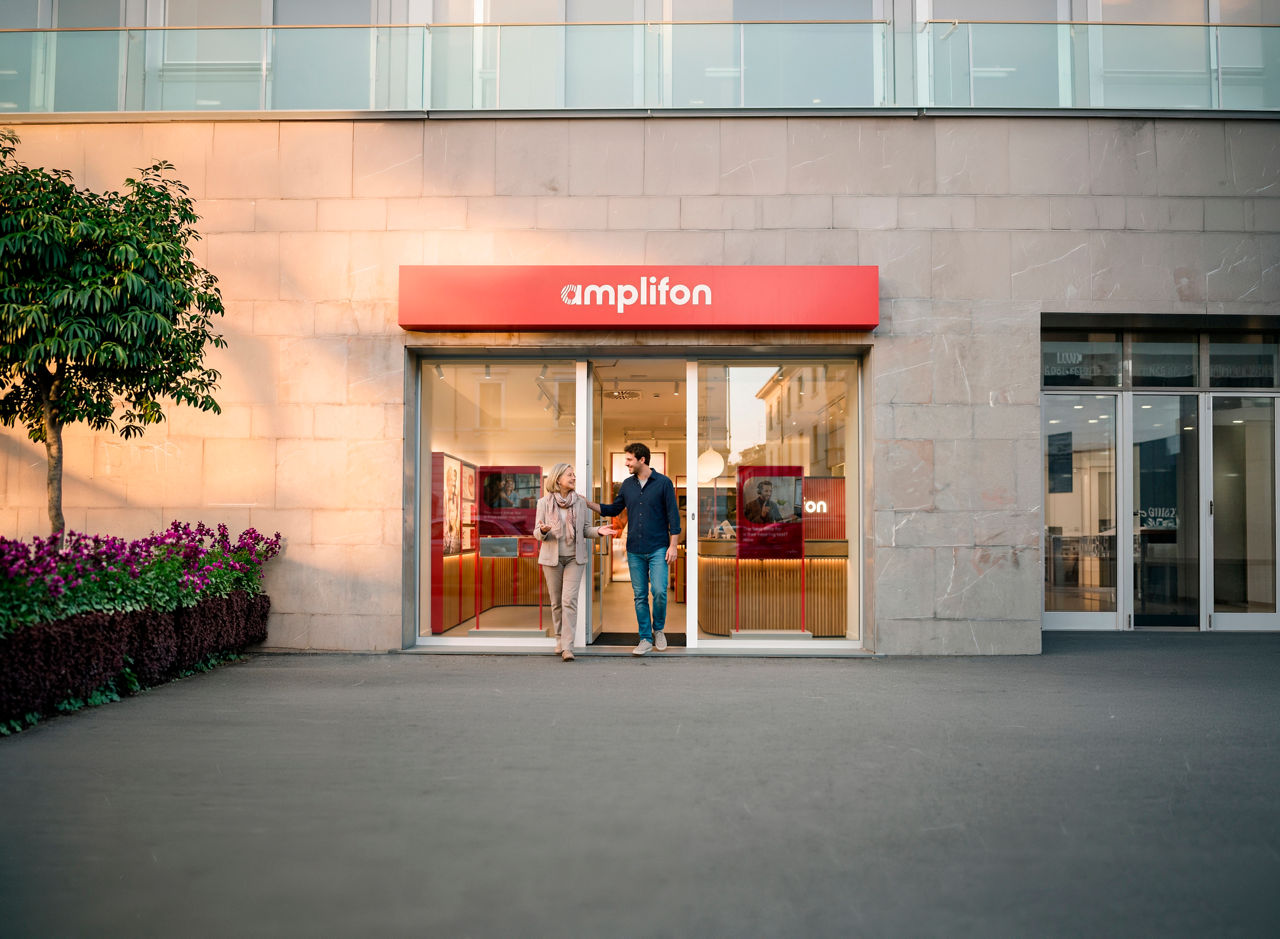People exiting amplifon storefront on city street