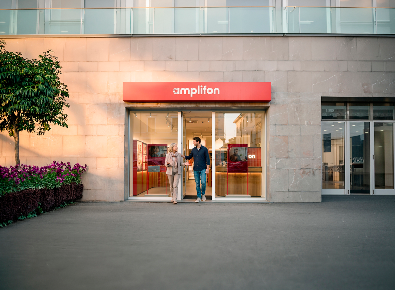 People exiting amplifon storefront on city street