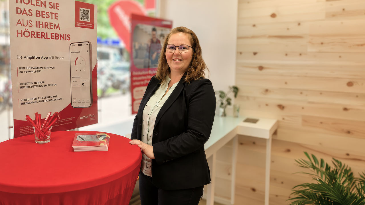 Businesswoman at promotional booth with poster