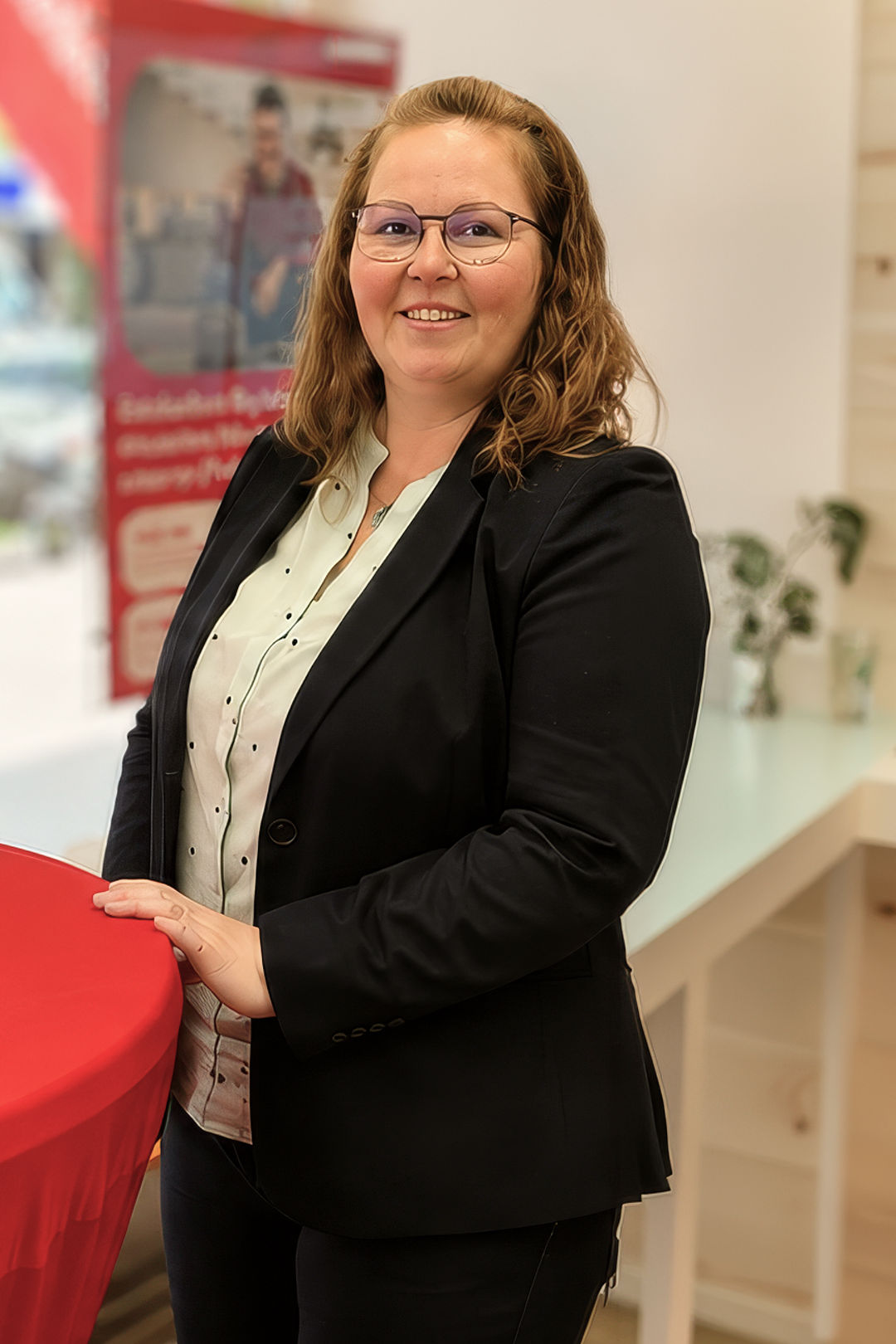 Businesswoman at promotional booth with poster