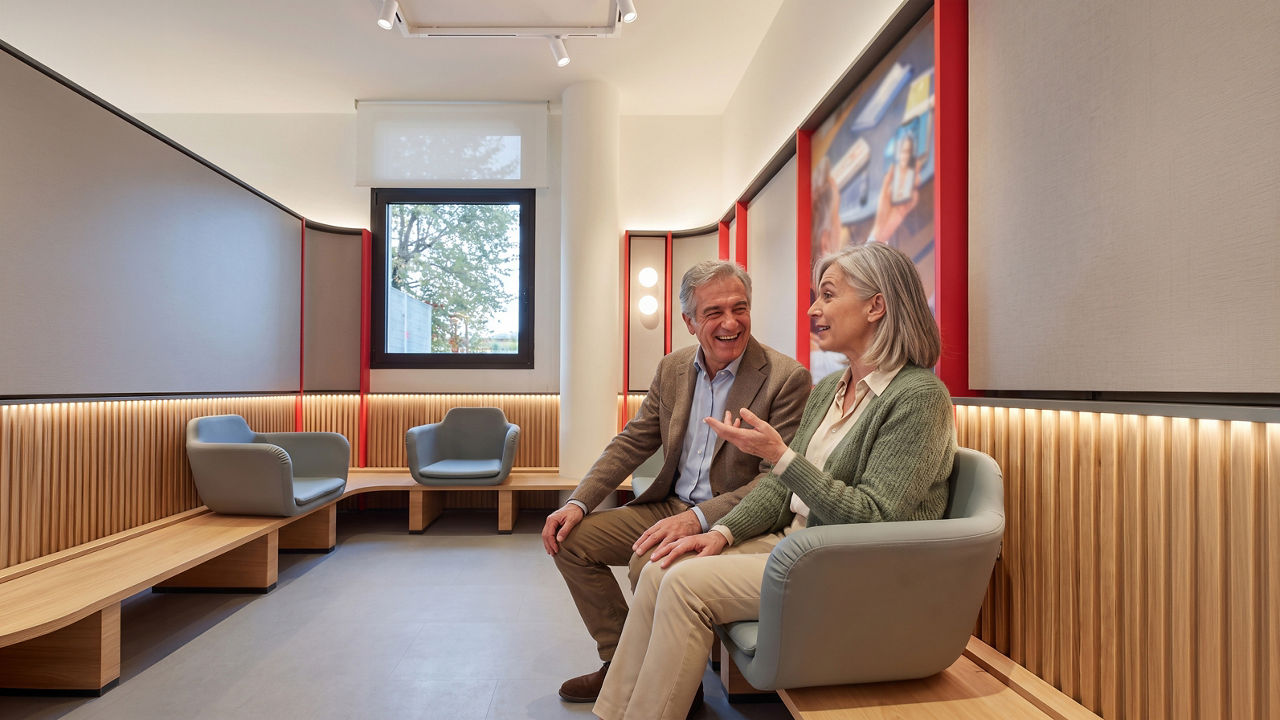 Mature couple talking in modern waiting room