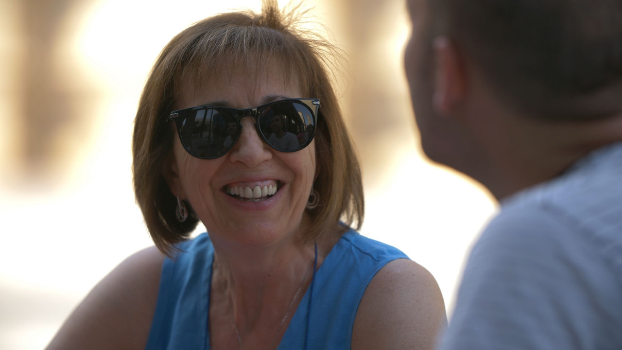 Smiling woman wearing sunglasses outdoors