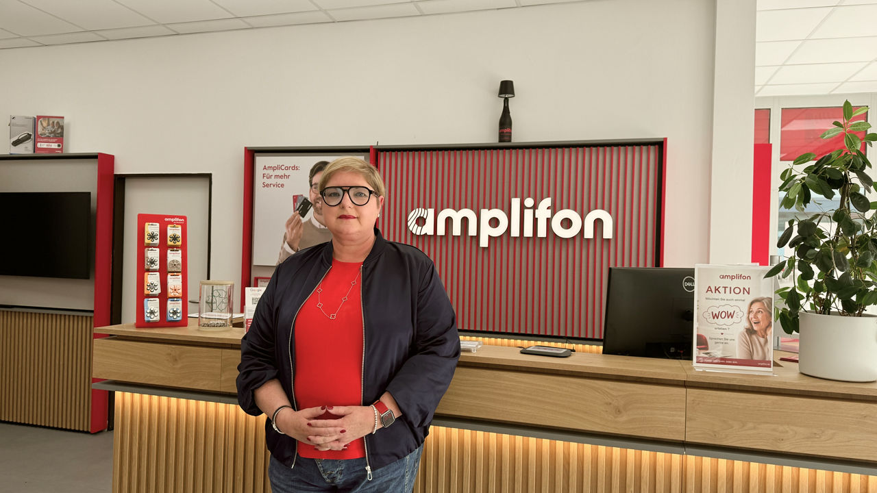 Woman standing in modern Amplifon store