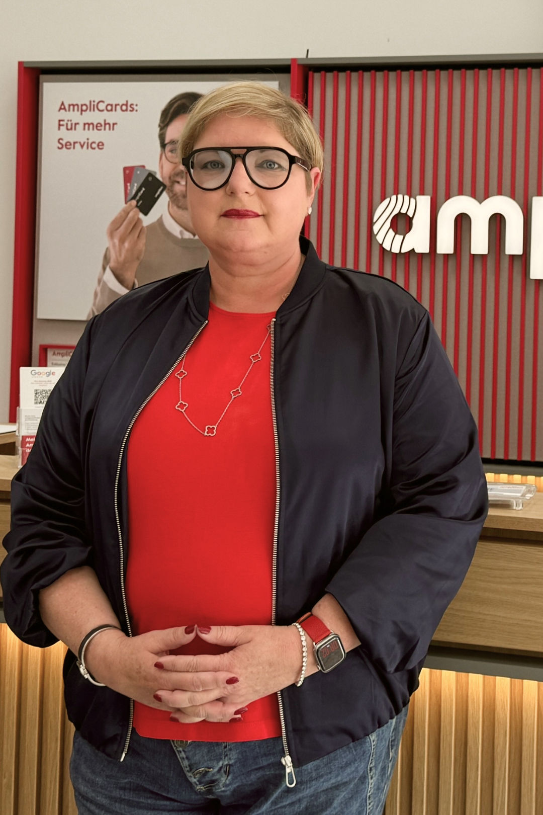 Woman standing in modern Amplifon store