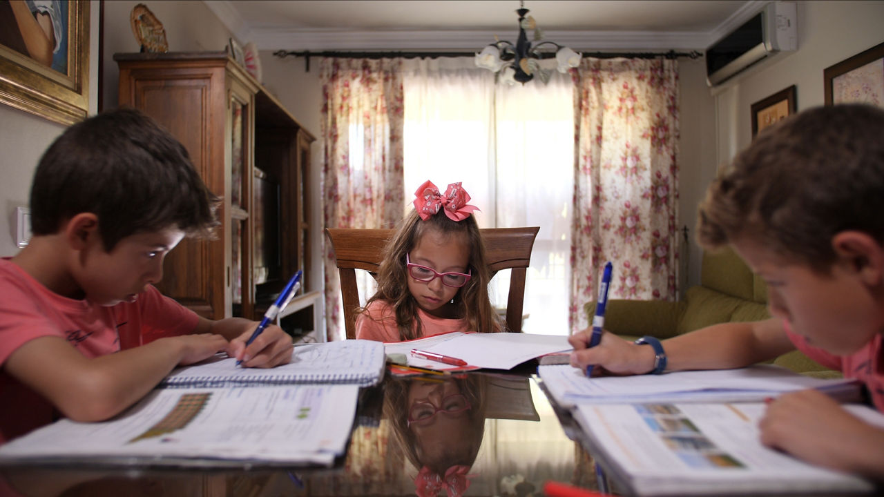 Children doing homework together at table