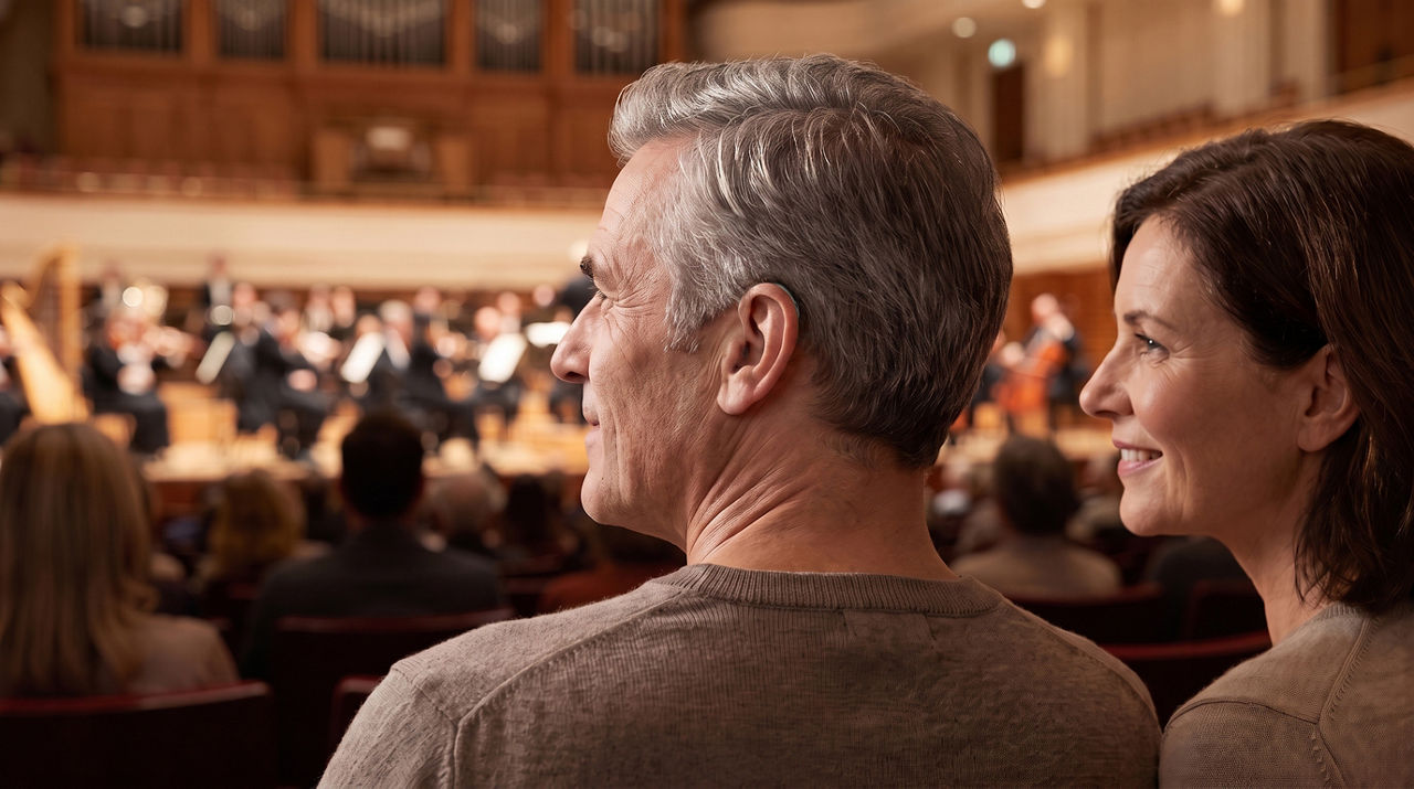Middle-aged couple enjoying classical concert