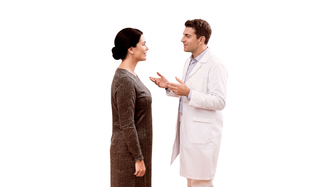 Doctor examining female patient's ear