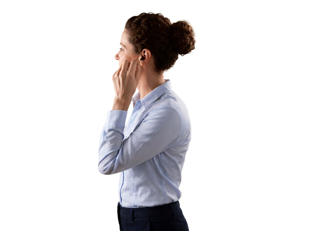 Woman adjusting wireless earbud in profile