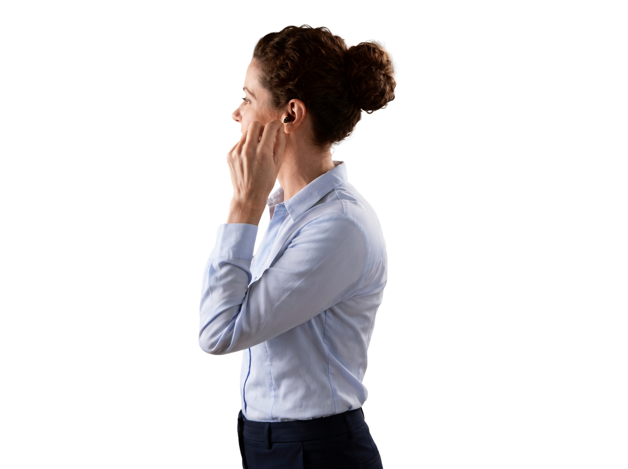Woman adjusting wireless earbud in profile