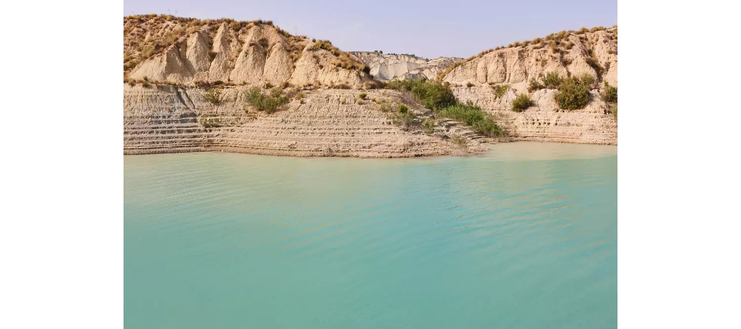 Badlands landscape and blue waters in Algeciras reservoir. Murcia, Spain