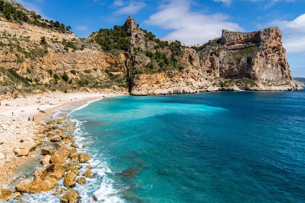 Moraig: A natural cove with rocks on the shoreline