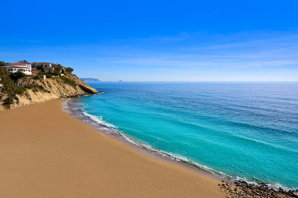 Cala Lunaza: An empty golden sand beach seen from above