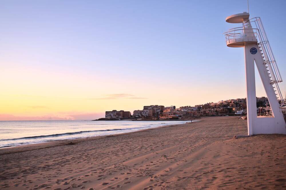 La Mata: Golden sand beach at sunset with a lifeguard chair